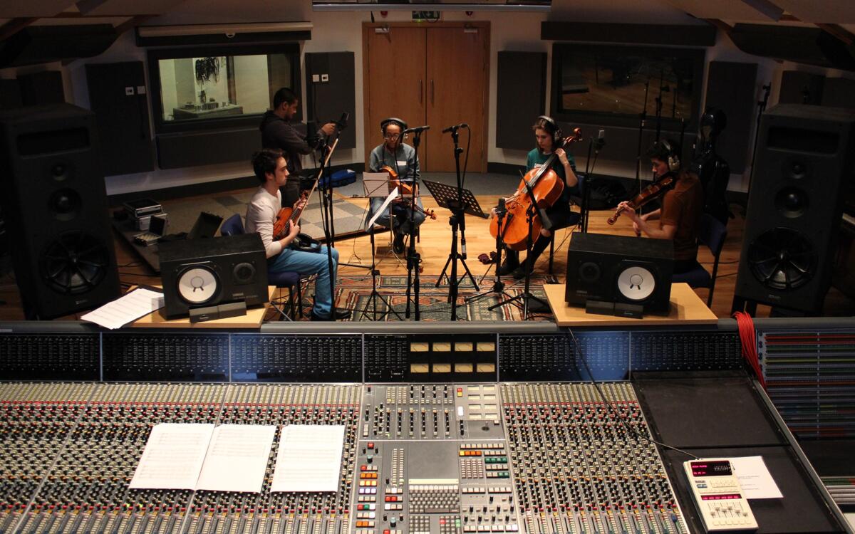 Sound engineering course student recording a string quartet in Spirit Studio