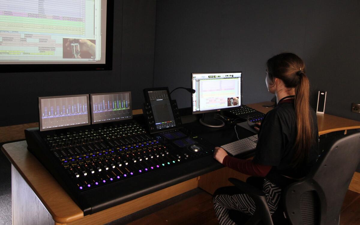 Student mixing audio for video. S6 Suite