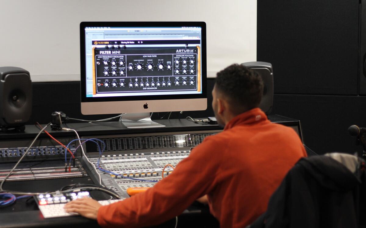 Music production student using a DAW plugin for post production