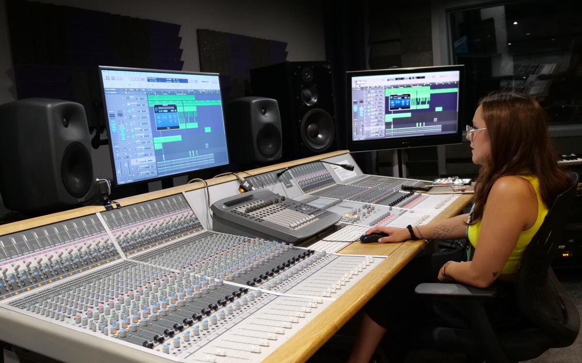 Spirit Studios student in front of 2 monitors running Logic PRO in Audient Studio 4