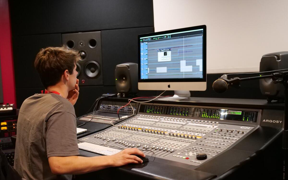 Student in the C24 Studio mixing and mastering vocals on pro tools.