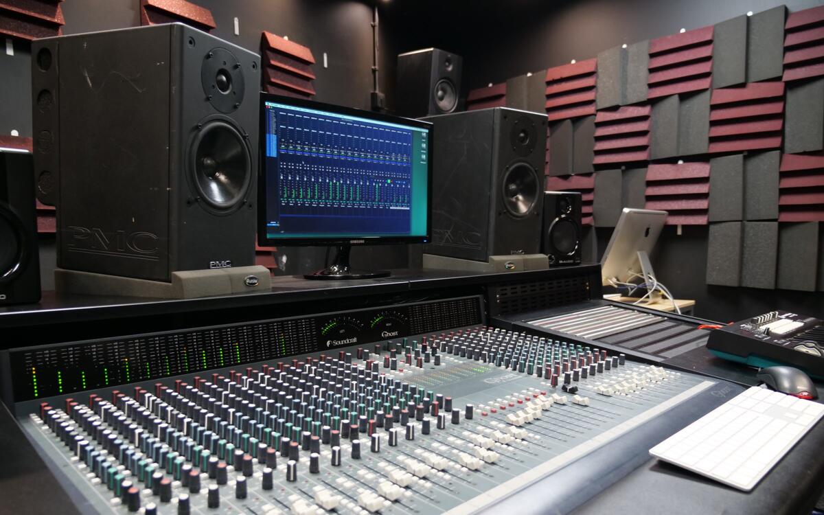 Inside the project studio showing the speakers and mixing desk