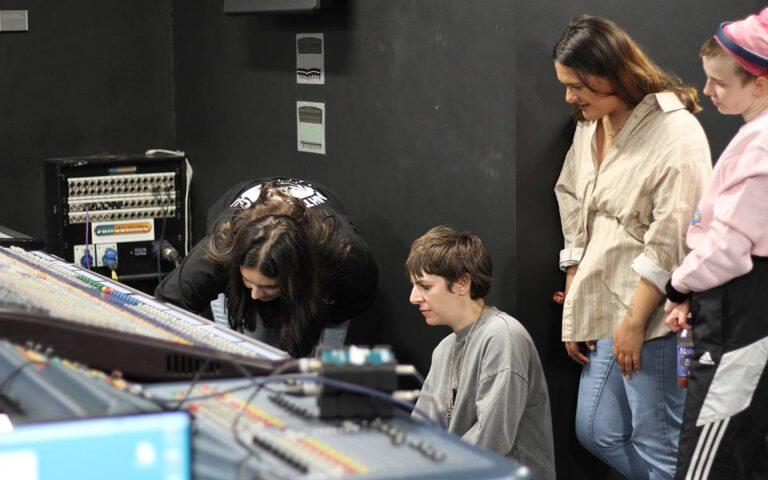 Kels Brooks showing how to sound engineer an acoustic set in a mixing console.