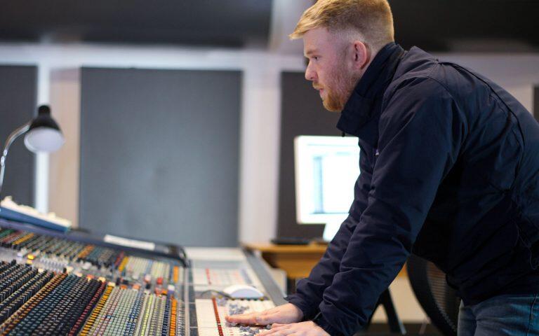 Tom standing in the studio on his computer