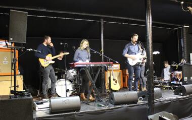 Band setting up on stage to perform inside the Charlie Jones Venue