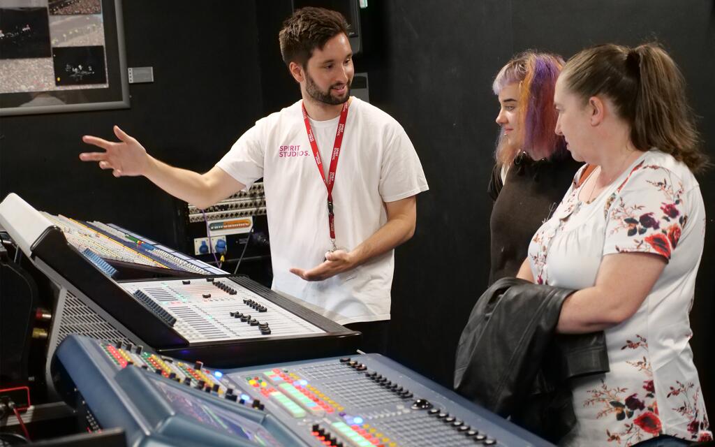 Lewis showing potential students around an open day at Spirit Studios