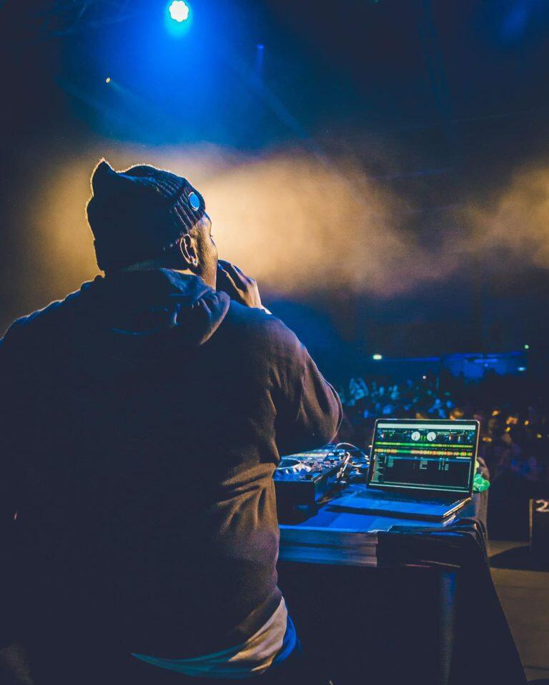 Aaron performing on stage with a full audience